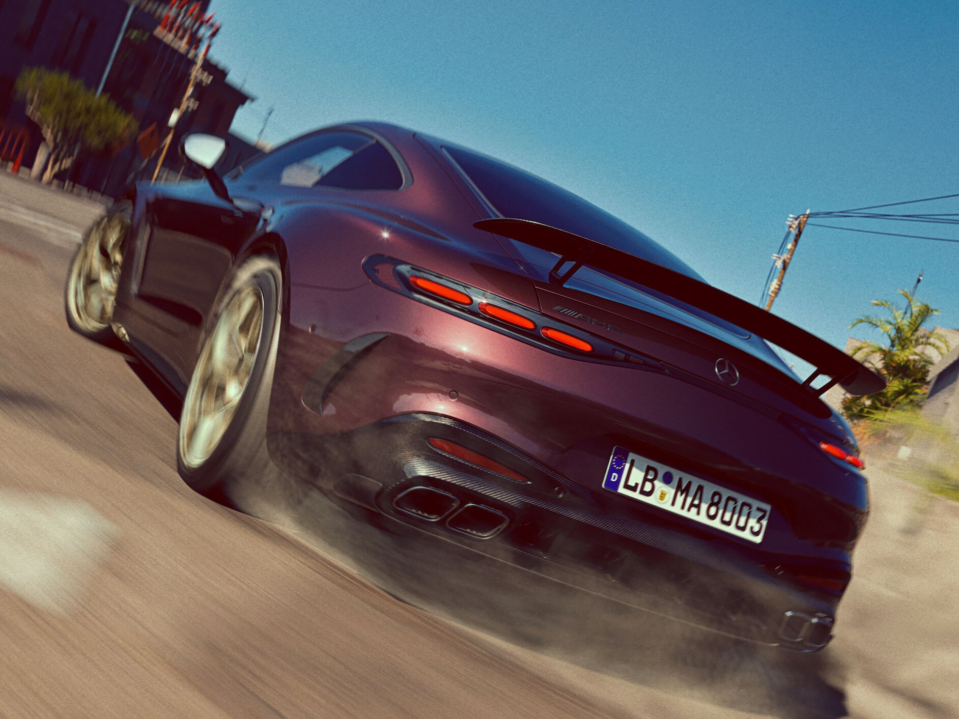 Tył modelu GT Coupé marki Mercedes-AMG jadącego szybko ulicą.