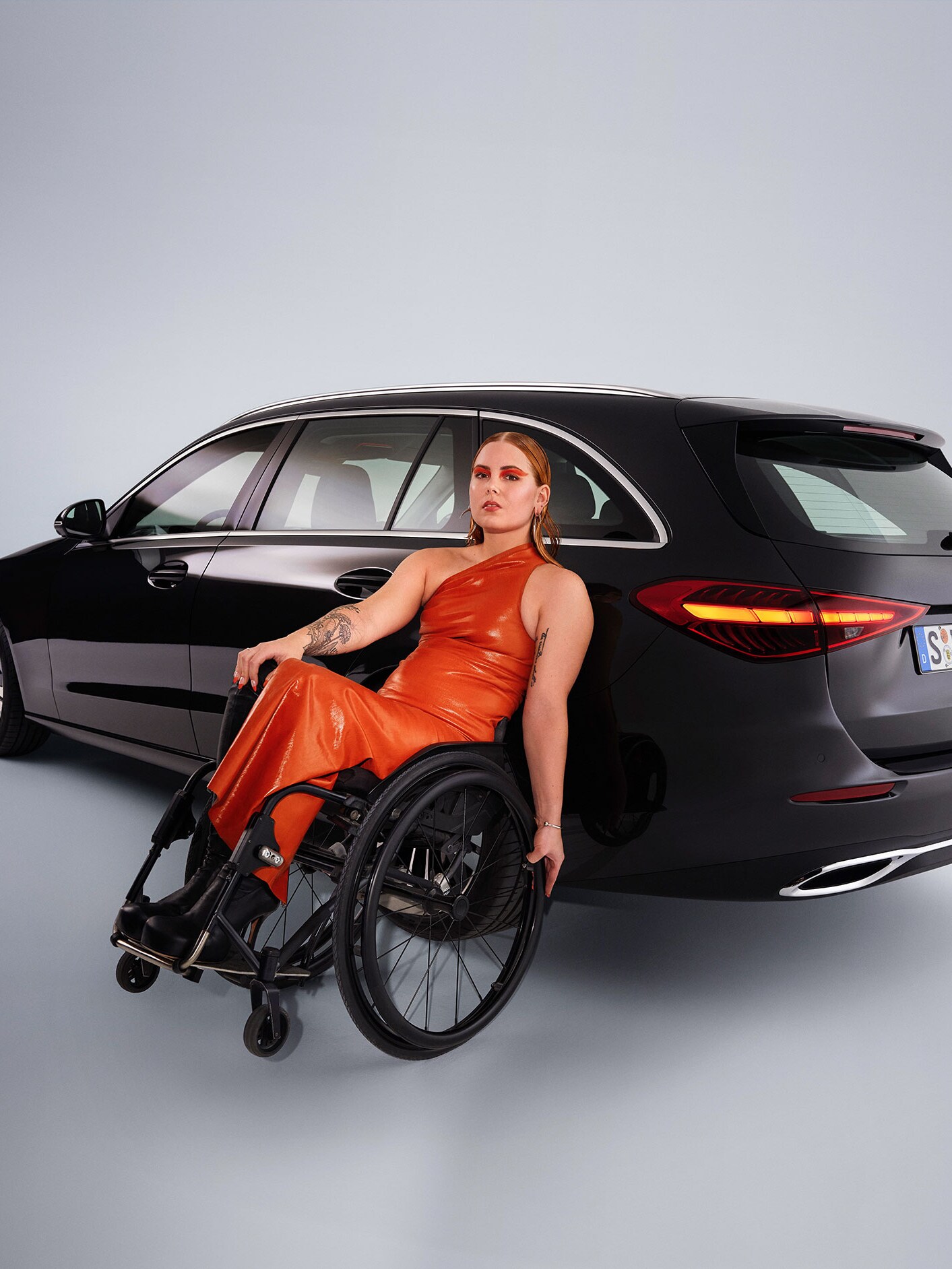 Klasa C Kombi w widoku z tyłu i kobieta na wózku inwalidzkim na pierwszym planie.