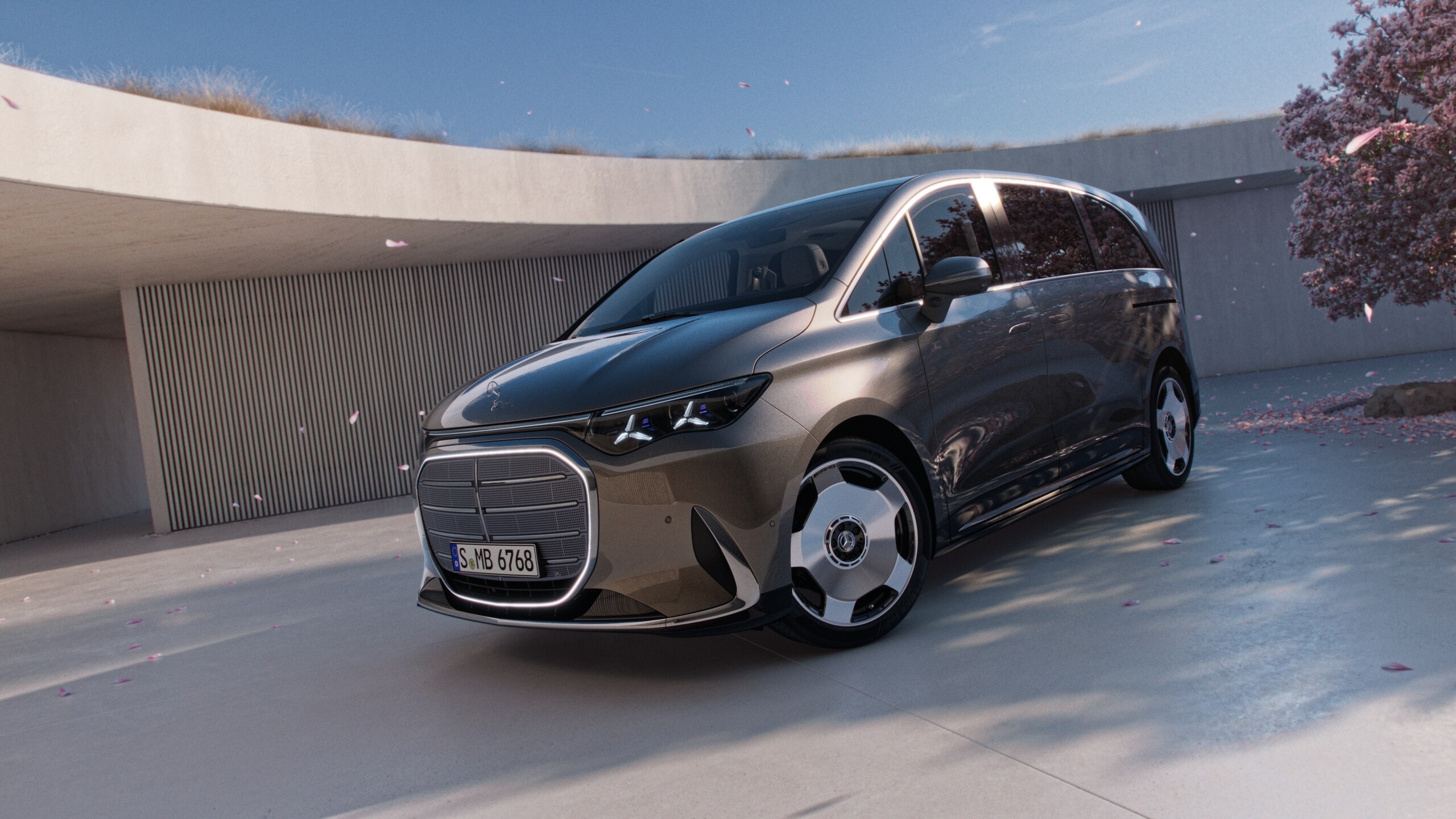 Srebrny, elektryczny model VLE zaparkowany na nowoczesnym placu.