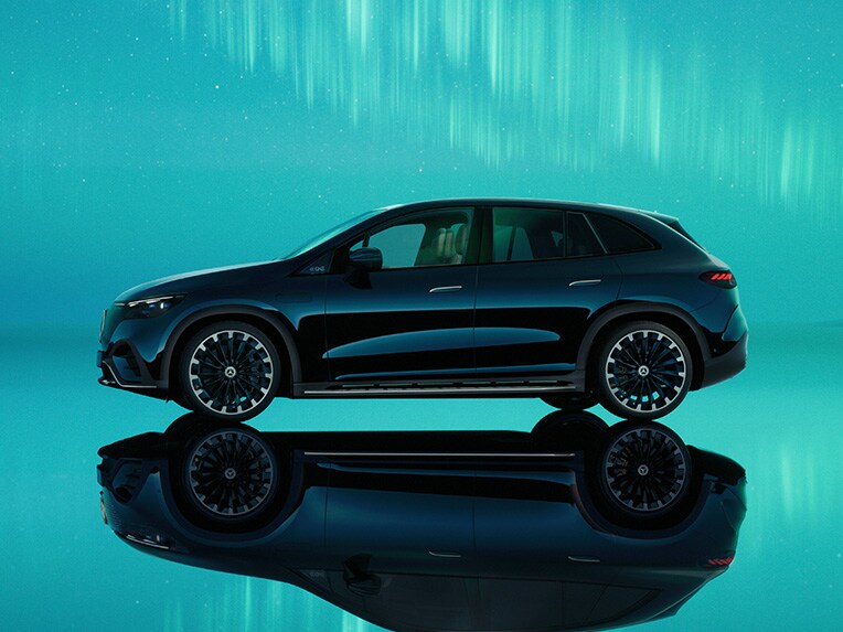 Zdjęcie przedstawia EQE SUV od Mercedes-Benz na tle zorzy polarnej.
