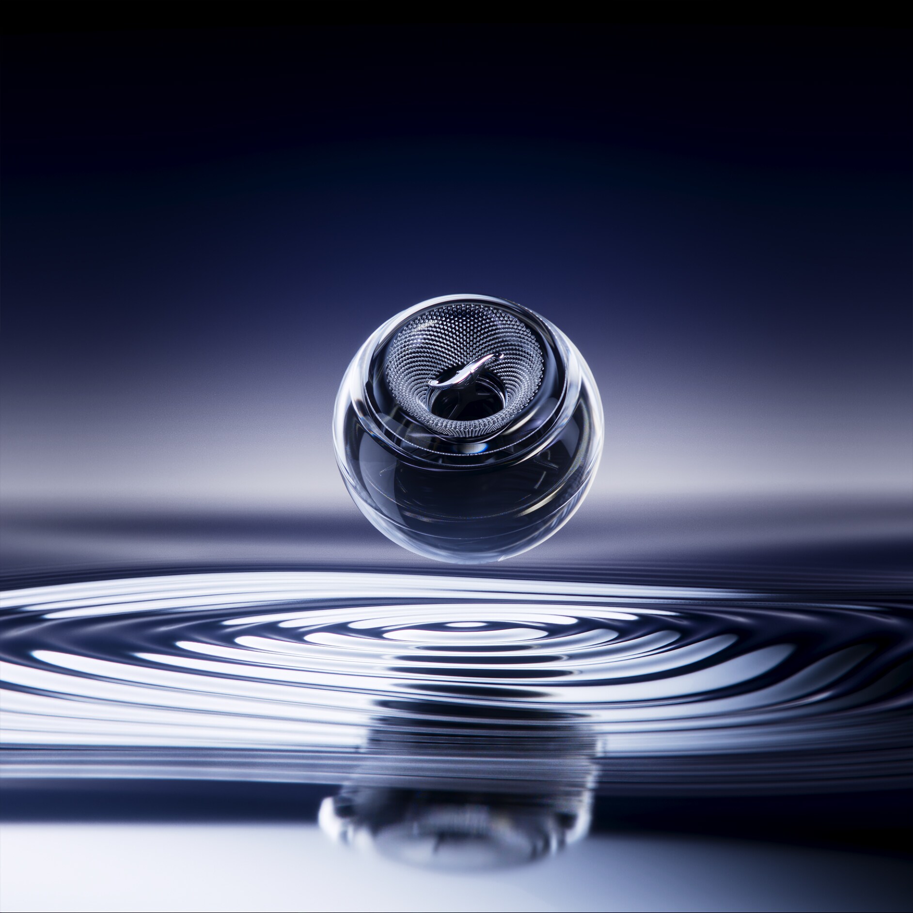 Głośnik unosi się nad powierzchnią wody, a pod nim tworzą się delikatne fale.