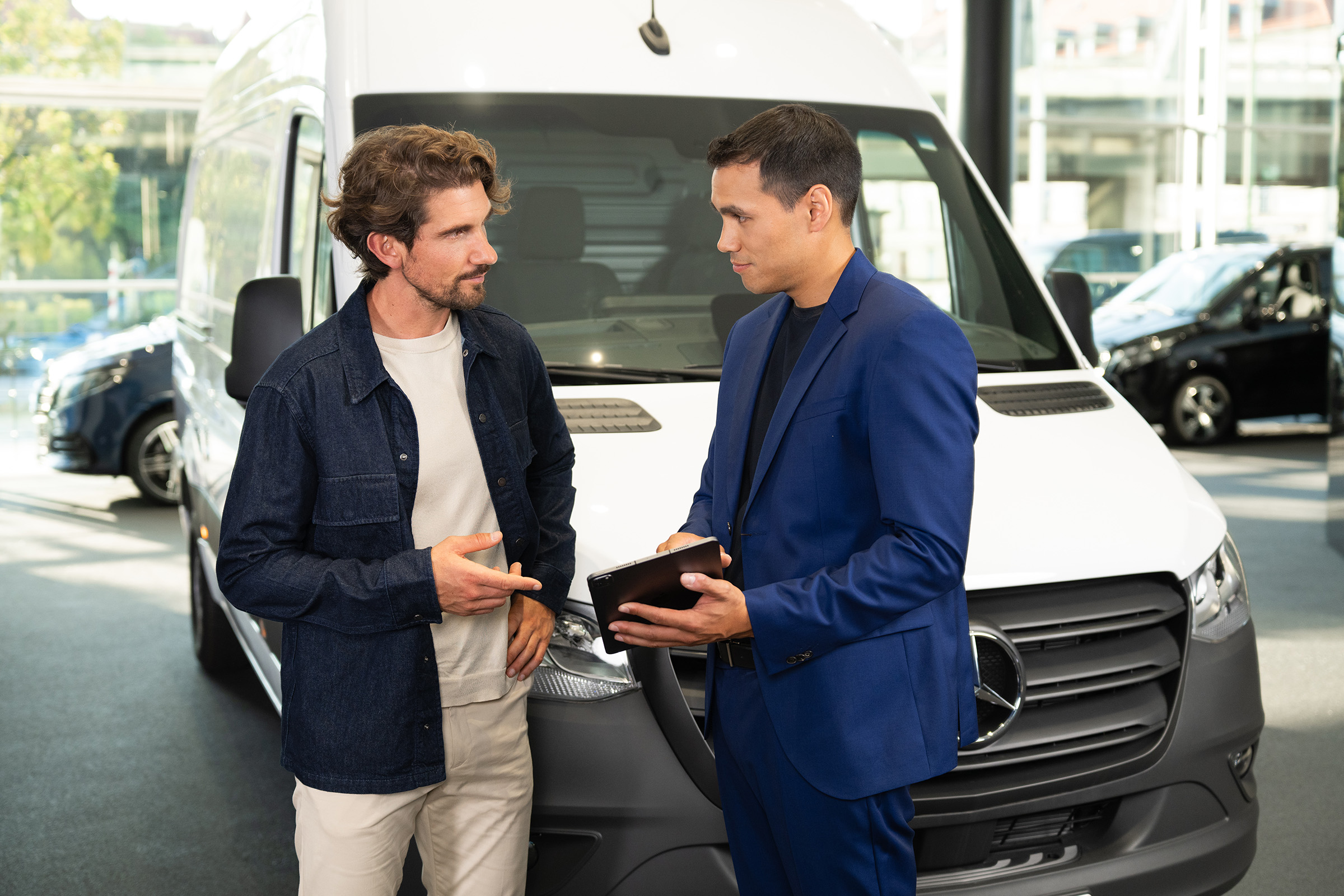 Leasing i pożyczka | Modele elektryczne | Mercedes-Benz Konsultacje dotyczące samochodów dostawczych Mercedes-Benz w salonie, z naciskiem na obsługę zorientowaną na klienta.