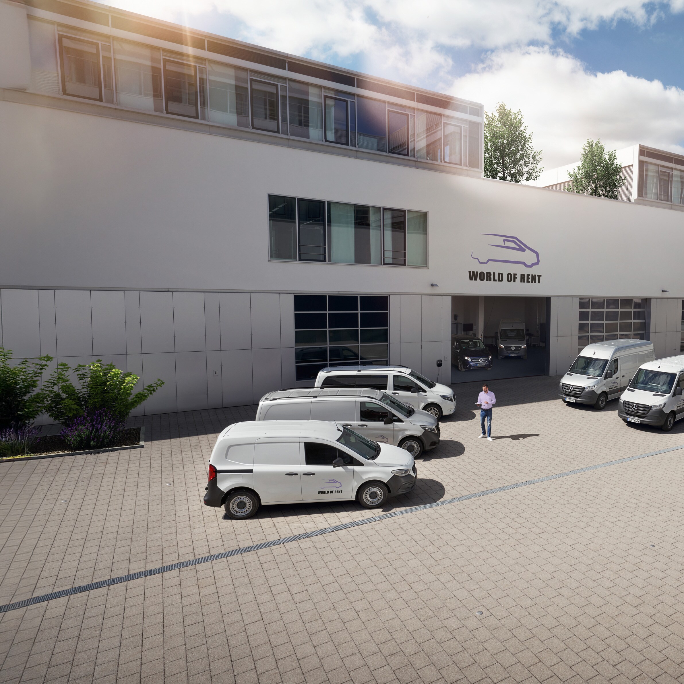 Flota pojazdów Mercedes-Benz przed budynkiem firmy.