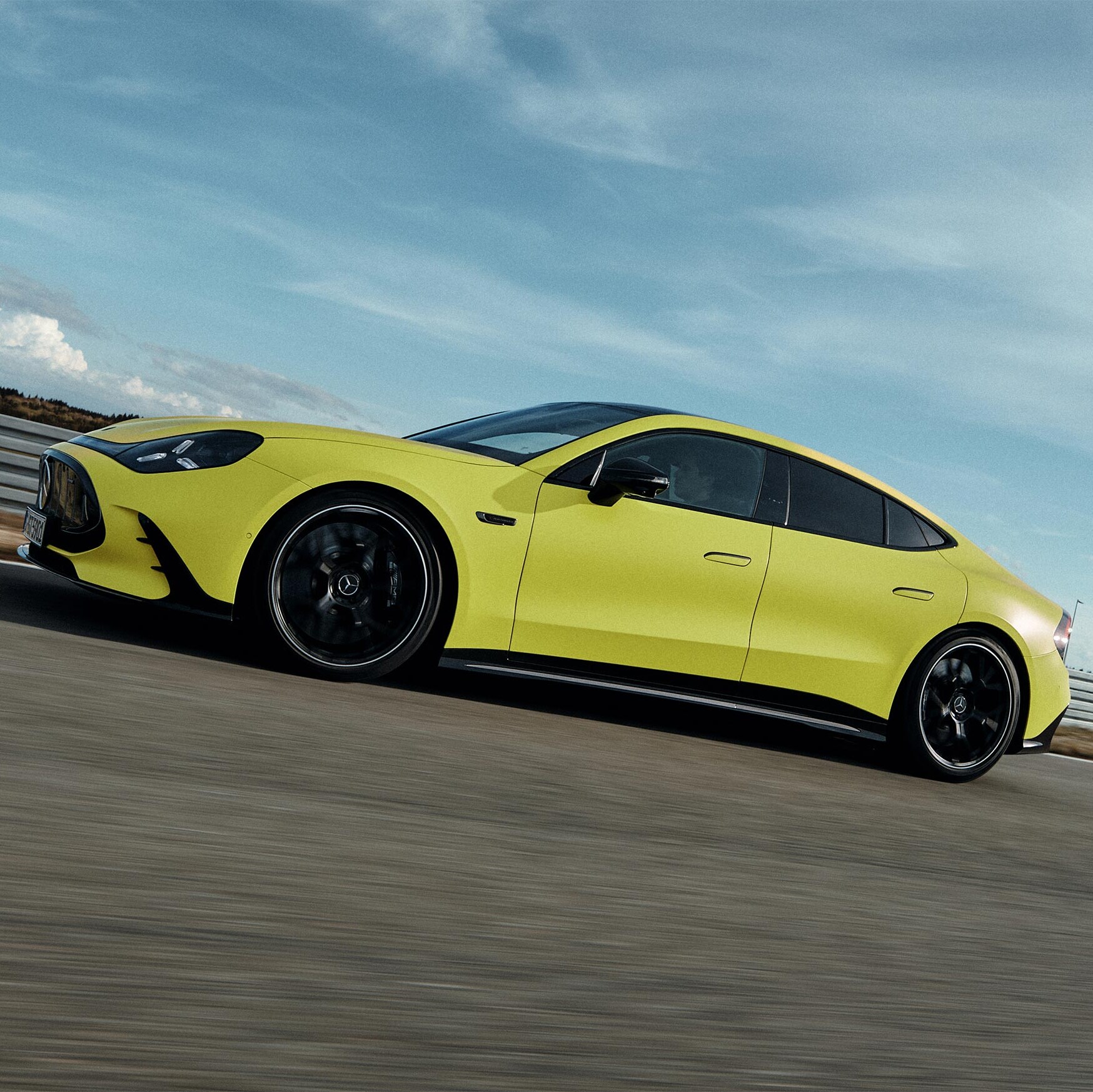 Żółty Mercedes-AMG GT 63 4-Door Coupé na torze wyścigowym.
