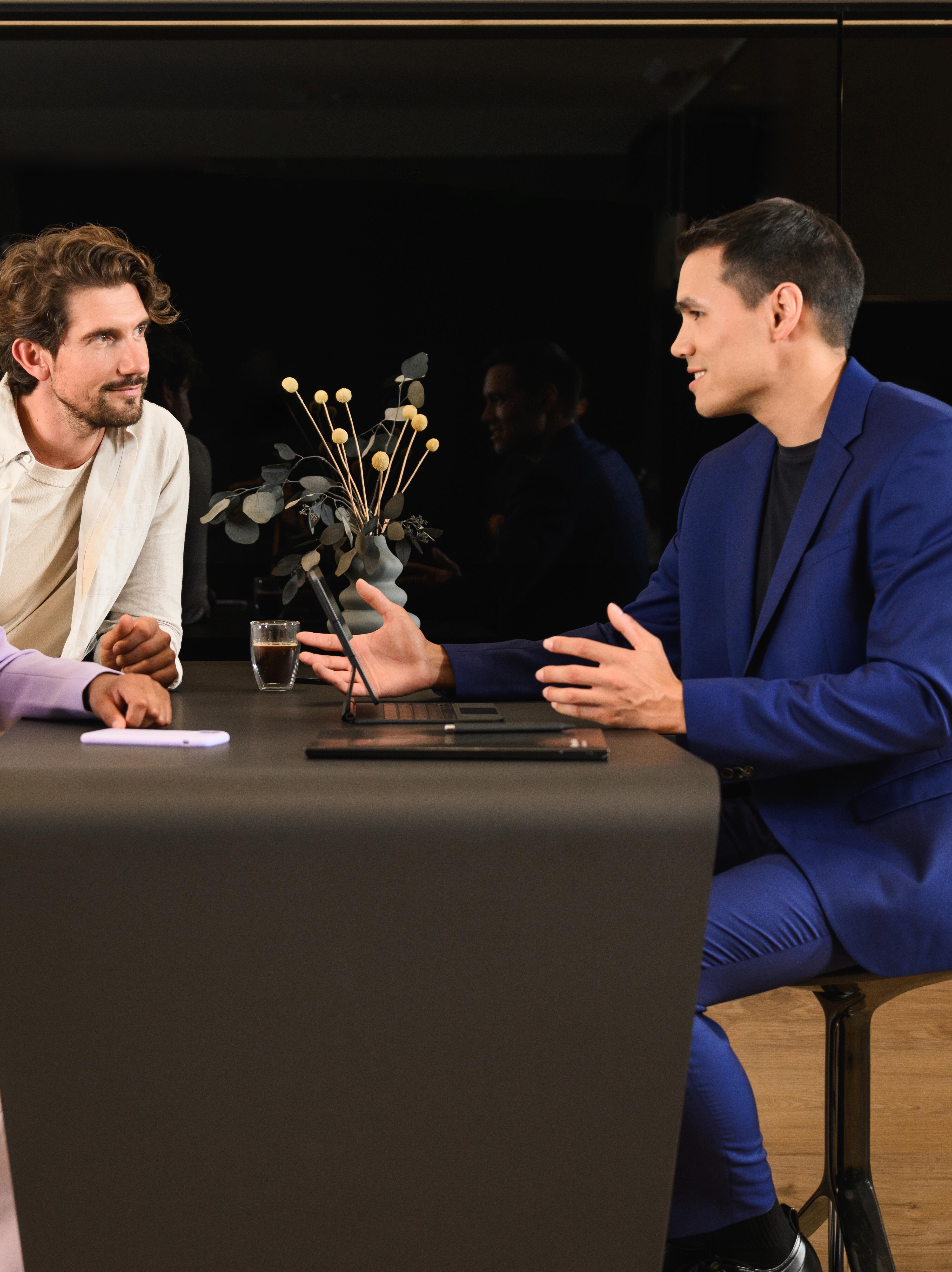 Trzy osoby siedzące przy jednym stole.