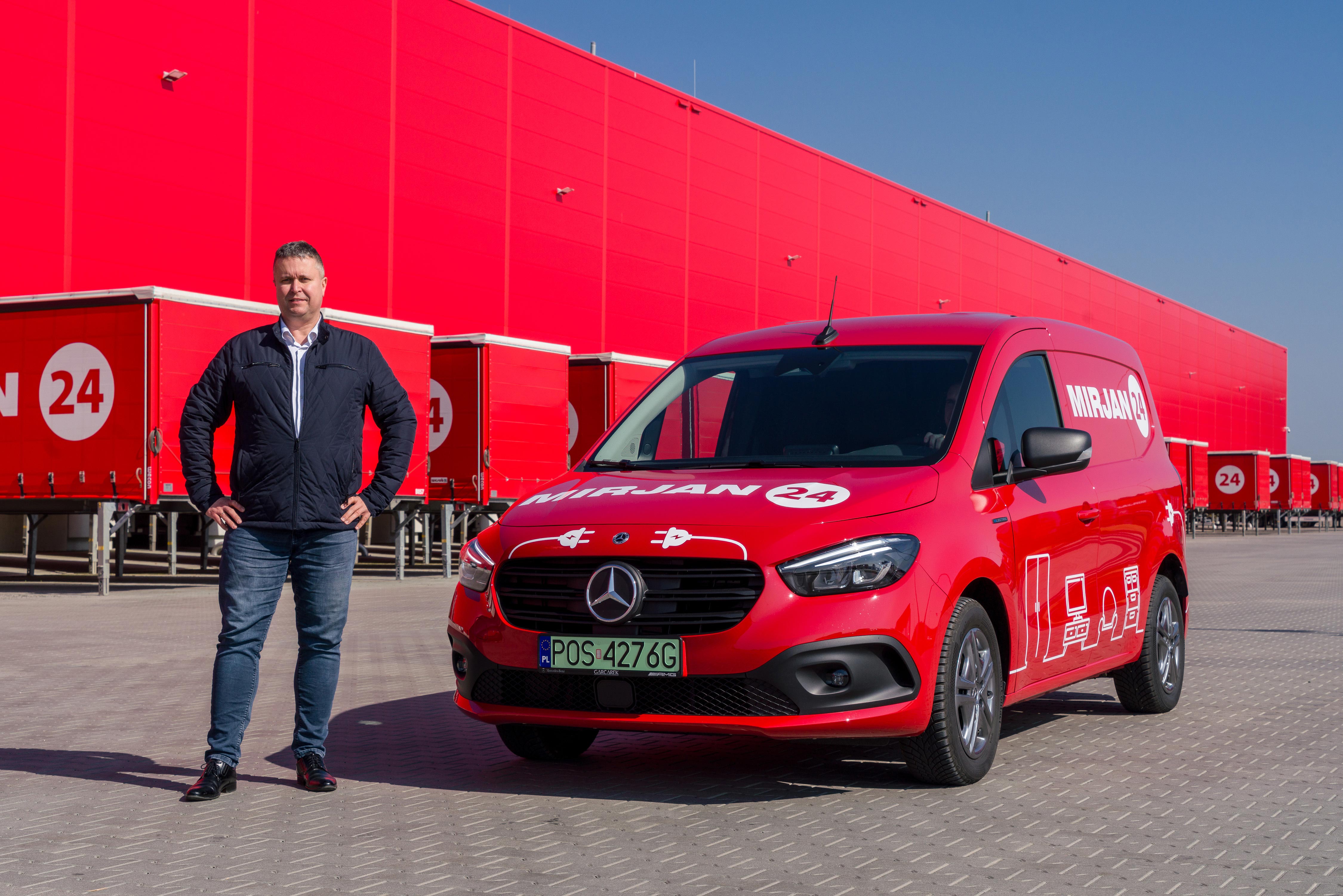 eCitany w firmie Mirjan24: niezawodne wsparcie na każdy dzień | Mercedes-Benz Czerwony eCitan Furgon na tle magazynu firmy Mirjan24.